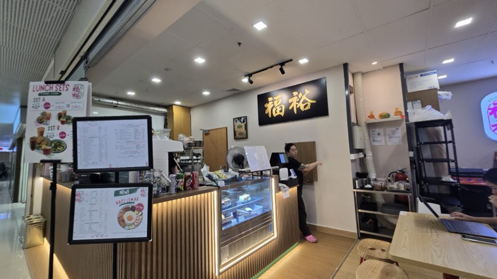 Inside Mighty Kopi: the service counter, menu Menus and the 福裕 sign above the kitchen